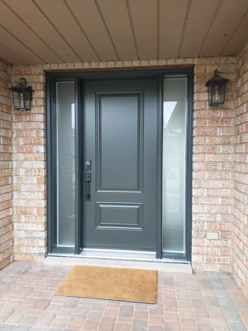 Grey front door with two frosted sidelights on a brick porch, installed by Panorama Windows & Doors Grey front door with two frosted sidelights on a brick porch