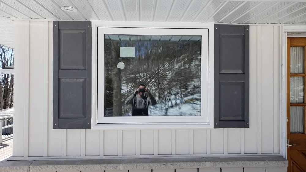 Picture and casement windows on board-and-batten siding, installed by Panorama Windows & Doors Picture and casement windows on board-and-batten siding