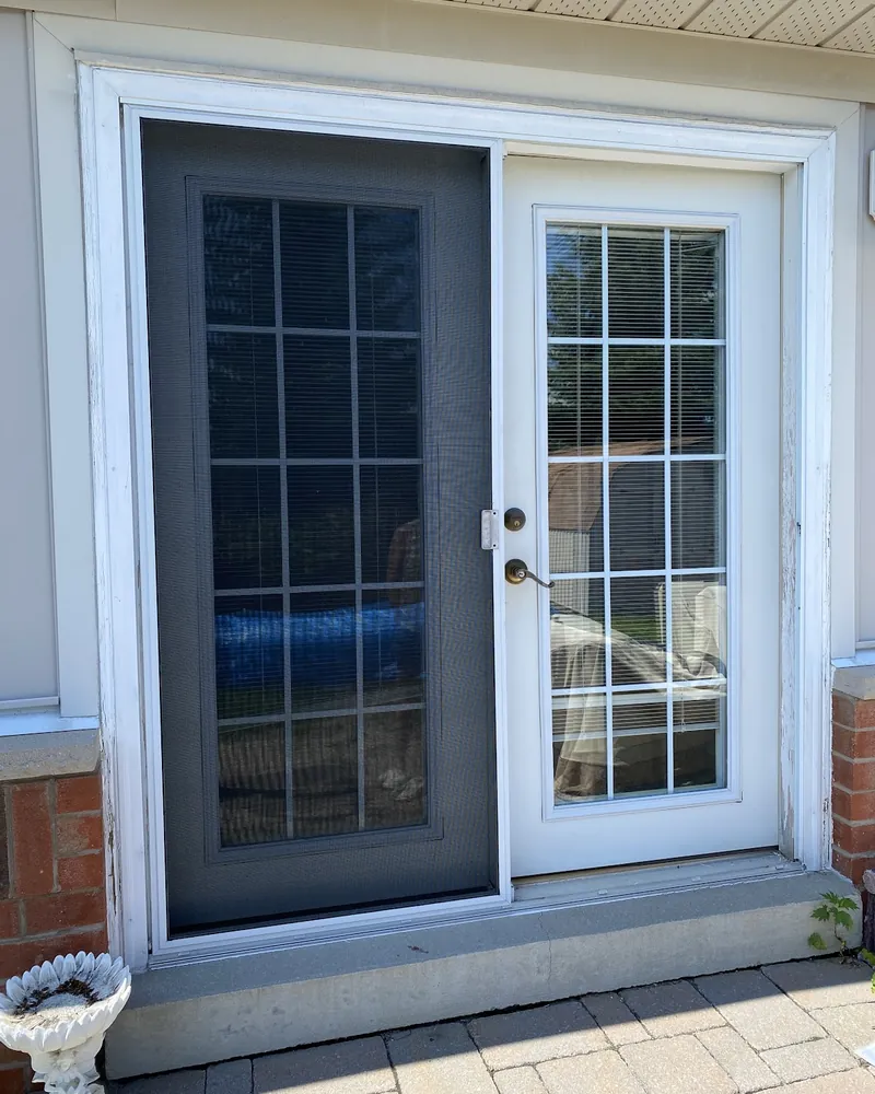 Garden Door to White French Doors: before Patio doors on a siding wall before replacement