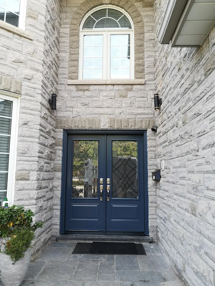 Navy double doors on a stone home in Hamilton, installed by Panorama Windows & Doors Navy double doors on a stone home in Hamilton